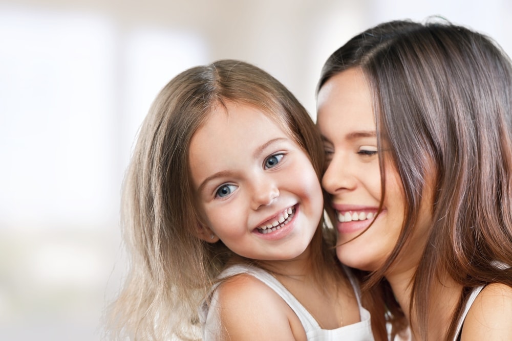 mom and daughter smiling