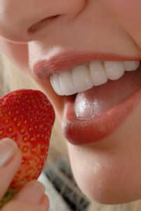 Person eating strawberry