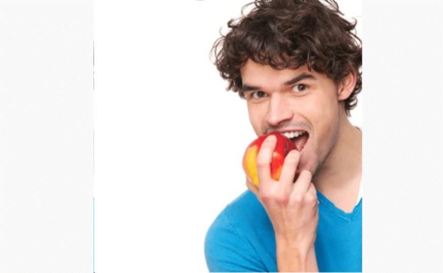 Cheeky man bites into an apple with a wonky bite.